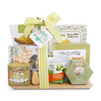 Gift basket with assorted snacks and a cheese knife on a white background