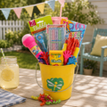 Yellow bucket filled with outdoor toys and supplies on a wooden table outdoors.