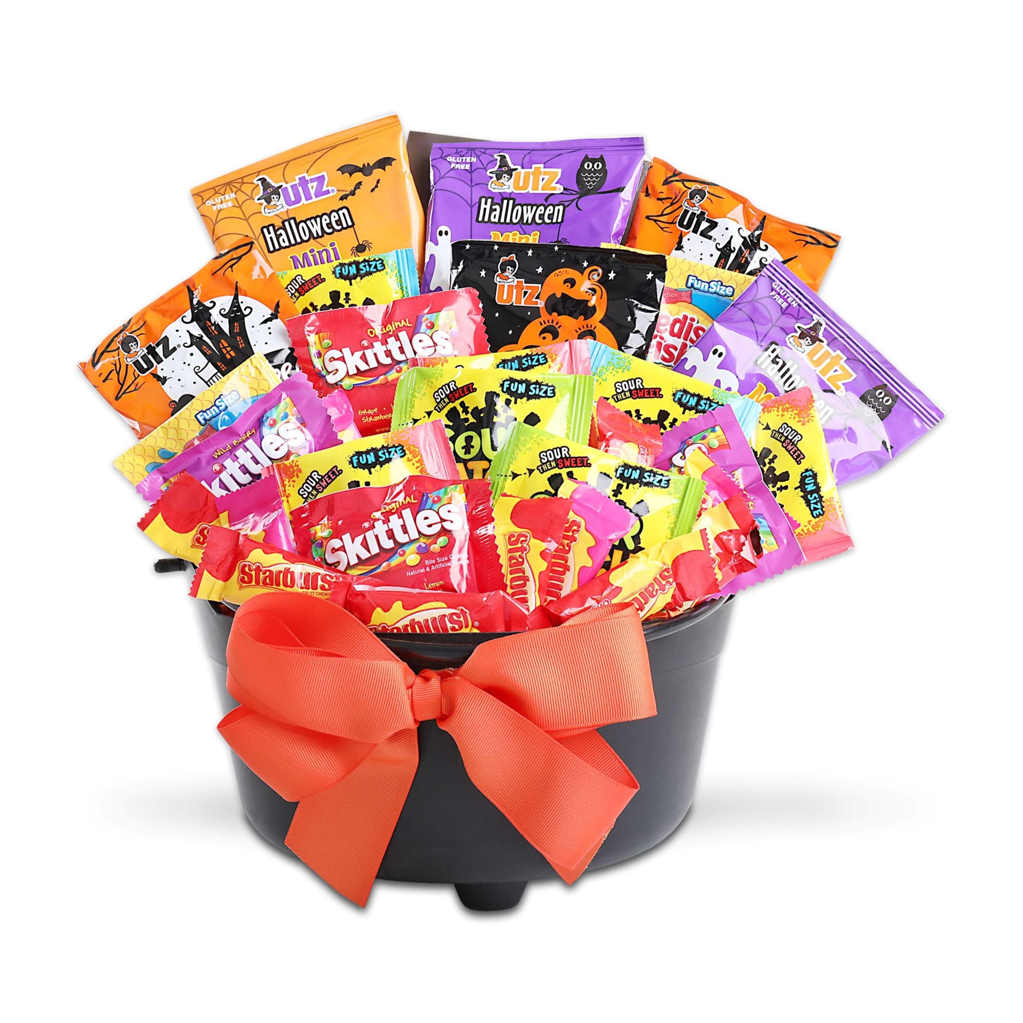 A Halloween-themed candy gift basket featuring a black bucket filled with candy packages, tied with a large orange bow.