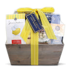Gift basket with a yellow ribbon and various products inside on a white background