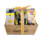 Gift basket with  Farmers Market branding, featuring a variety of products including a bottle of lemonade and packaged goods.