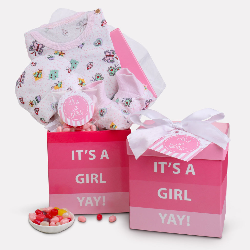 Baby girl gift set with pink box and baby clothes on a white background